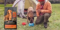 owner and dog camping with Pro Plan package to the side
